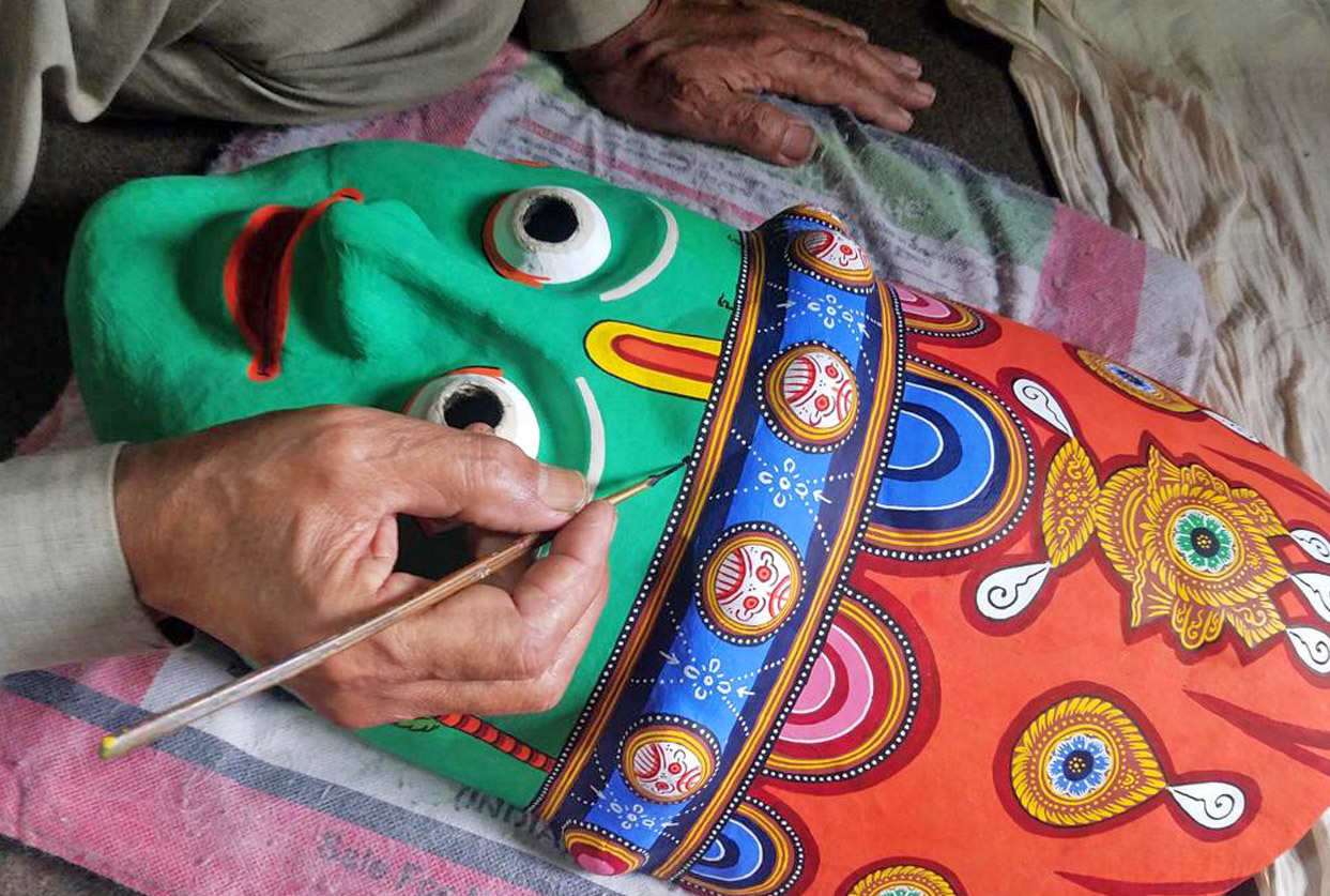 The hand of the artist Purna Bahadur Chitrakar painting final details on a mask for the Nava Durga dance, Bhaktapur, Nepal. Courtesy of Renuka Guruing.