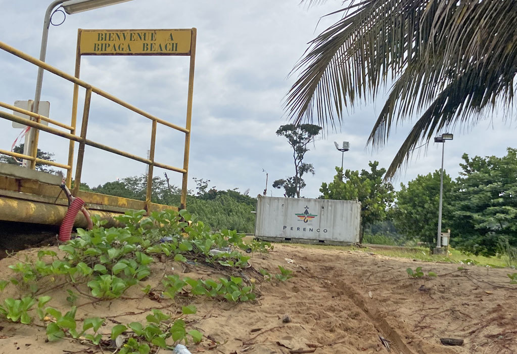 At Bipaga beach, South Cameroon, a container labelled Perenco welcomes visitors to the Société Nationale des Hydrocarbures gas processing plant. November 2023. Courtesy of Jeannot Ema’a, InfoCongo.